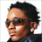 A split-frame contact sheet showing a person with short dark hair and sunglasses on the left, and a stylized "B2K" logo on the black background to the right.