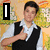 A static image of a person in a black vest and white shirt giving a thumbs-up gesture, with a group photo and text elements visible in surrounding sections.