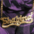 Golden cursive text spelling 'Shakira' on a purple and black draped fabric background with subtle pixelation.