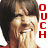A pixelated image of a person with dark hair covering their mouth with both hands, accompanied by red vertical text reading "OUCH LOVE BITES" on the right side.