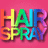 Pixelated 'HAIRSPRAY' text in rainbow gradient on pink background with surrounding white text phrases.