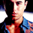 Pixelated static image of a person's face and upper torso in profile view with visible facial features, clothing details, and color gradients against a black background.