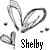 Pixelated grayscale icon with heart-shaped paperclip and floating hearts, featuring the name 'Shelby' in blocky text below.