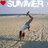 A pixelated beach scene with a person doing a handstand on sand, overlaid text reading 'SUMMER' and a red heart symbol.