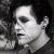 Static grayscale pixelated image of a person's face in profile view with visible facial features and hair against dark background.