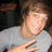 A pixelated image of a person in a gray shirt with a hand gesture, featuring cyan text reading 'Ryan <3' in the upper right corner.