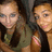 Two pixelated figures in close proximity, one with light hair and the other with darker hair, both wearing dark tops against a blurred background.
