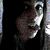 Four pixelated show a person with dark hair and red lips in different facial expressions against a light background