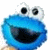 A 50x50 pixel animated buddy icon featuring a blue Sesame Street character with large eyes and open mouth on the left, paired with white text "C is for Cookies" on a solid blue background.