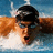 A swimmer in mid-stroke with goggles, mouth open, and arms extended forward through water.