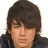 A pixelated image of a person with dark brown hair and a black jacket, featuring pink text reading "JOE BRO'S ROX!" above the head on the right side.