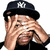 A person wearing a black cap with white NY logo covers their face with both hands in four
