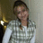 A pixelated static image shows a person with dark hair wearing a light-colored checkered shirt against a blurred background with warm and neutral tones.