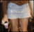 Static pixelated image of a light blue and brown object with indistinct features against a dark background.