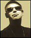 Four static portrait arranged in a , each showing a person with distinct facial features and clothing against a light brown background