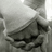 A grayscale animated icon shows a person in a hooded garment holding an object, with subtle motion changes across frames.