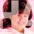 Pixelated image of a person with light skin tone, dark red hair, and a neutral expression, set against a pink background with dark red and gray geometric shapes.