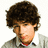 Pixelated image of a person with curly brown hair wearing a light gray shirt over a white collar and red undershirt, set against blue background with cyan text.