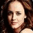 A woman with long brown hair appears in three distinct poses: a close-up, two women lying together, and a side profile.