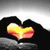 A heart-shaped icon with a gradient fill transitioning from yellow to red, set against a dark background with a light gray gradient top section.