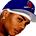 Pixelated close-up of a character's face wearing a blue and white cap with red accents, brown hair visible beneath the cap.