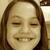 A pixelated image of a smiling person with long brown hair, showing variations in facial expression and cropping across four