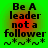 Green background with red gradient overlay displays text "Be A leader not a follower" and four asterisk-like symbols in pixelated font.