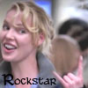 A static image shows a person with light brown curly hair holding a small brown dog, with the word "Rockstar" in black text at the bottom left.