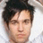 A pixelated close-up of a person with dark tousled hair against a light background, showing subtle facial expression differences between