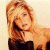 Pixelated image of a woman with long blonde hair wearing a black top, positioned next to green text reading 'Original Icons .com' on a dark background.