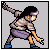 Pixelated character in dynamic pose with outstretched arm, wearing light brown shirt and purple shorts against gray background.