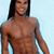 Pixelated image of a shirtless person with long dark hair against a light blue background, smiling with visible teeth.