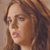Pixelated close-up of a person with brown hair, closed eyes, and pink lips against a light brown background.
