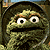Green background with pixelated text and a character image; repeated 'GROUCH' text in black with red underlines, two instances of 'proud to be a', and small star symbols.