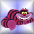 Pixelated cartoon character with purple body, red-and-blue striped hat, yellow eyes, and wide white-toothed grin against light blue background.