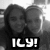 Two people in grayscale pose closely together with a pixelated background and bold white text reading "ILY!" at the bottom.