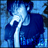 A person in a dark shirt holds a microphone near their mouth, with blue-tinted text reading 'thursday' below them across six