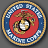 Circular icon with gold border, blue and white checkered ring, red center featuring eagle-globe-anchor symbol.
