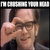 Pixelated image of a person with short dark hair holding a phone to their ear, wearing a dark shirt against a blurred background.