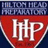 A static image with a blue background, red text, and a shield-shaped emblem containing 'HHP' in white letters.