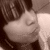 A sepia-toned close-up of a person with dark hair and bangs, showing subtle facial expression changes