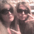 Two people with long hair and sunglasses in a pixelated photo, with pixelated text on a black background.
