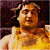 Static image of a person in yellow attire against dark background with green text reading 'Original Icons .com' on right side.