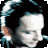Pixelated image of a person with dark hair and light skin, showing three sequential facial expressions with text "Dave Gahan" below.