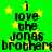 Green background with yellow stars and black text reading "i love the jonas brothers" in pixelated font.