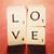 A static pixelated icon displays the word 'LOVE' in four quadrants on a light background with red and dark brown borders.
