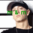 A person wearing a dark cap and black shirt with green text 'm & m' overlaid on the face, shown in four with slight head movement
