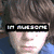 Pixelated image of two figures with text overlays; one wears a red cap and white shirt, the other has brown hair.