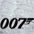 Black '007' text with a gun barrel graphic on a light gray pixelated background.