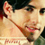 Pixelated close-up of a person's face with light skin, dark hair, and a red mark on the ear, wearing a light-colored top.